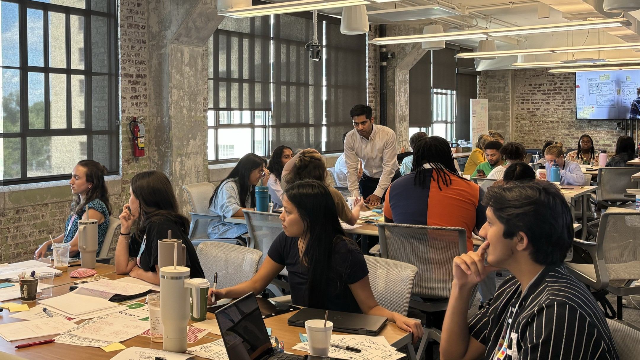 Yogesh Singh explaining Design Thinking concepts to a group during a workshop.